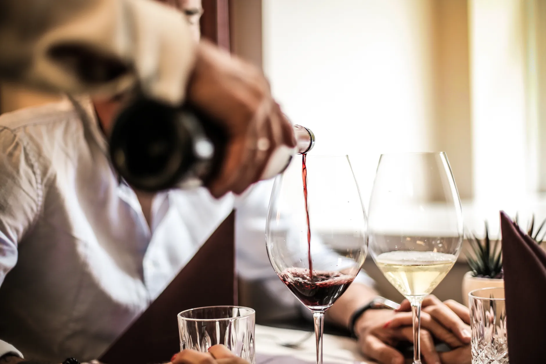 Pouring wine in a glass at the restaurant